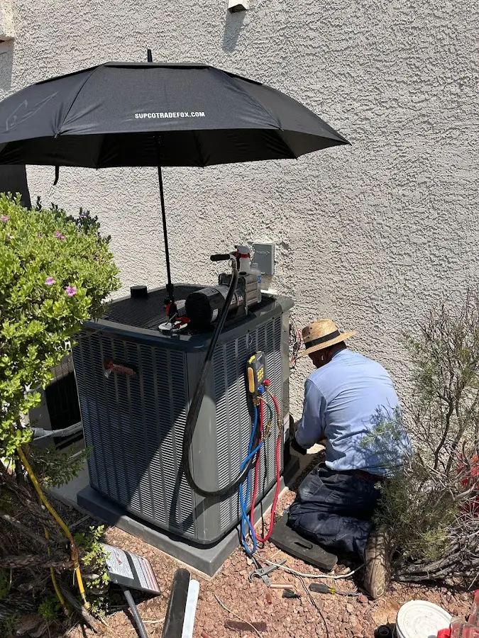 HVAC technician performing outdoor AC maintenance in York