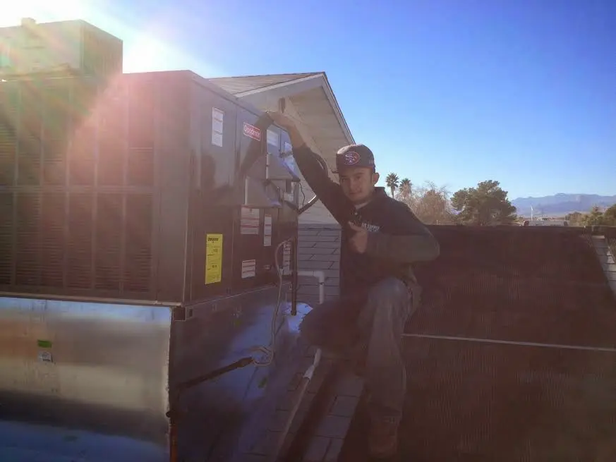 HVAC technician performing HVAC Inspection on a rooftop unit in York
